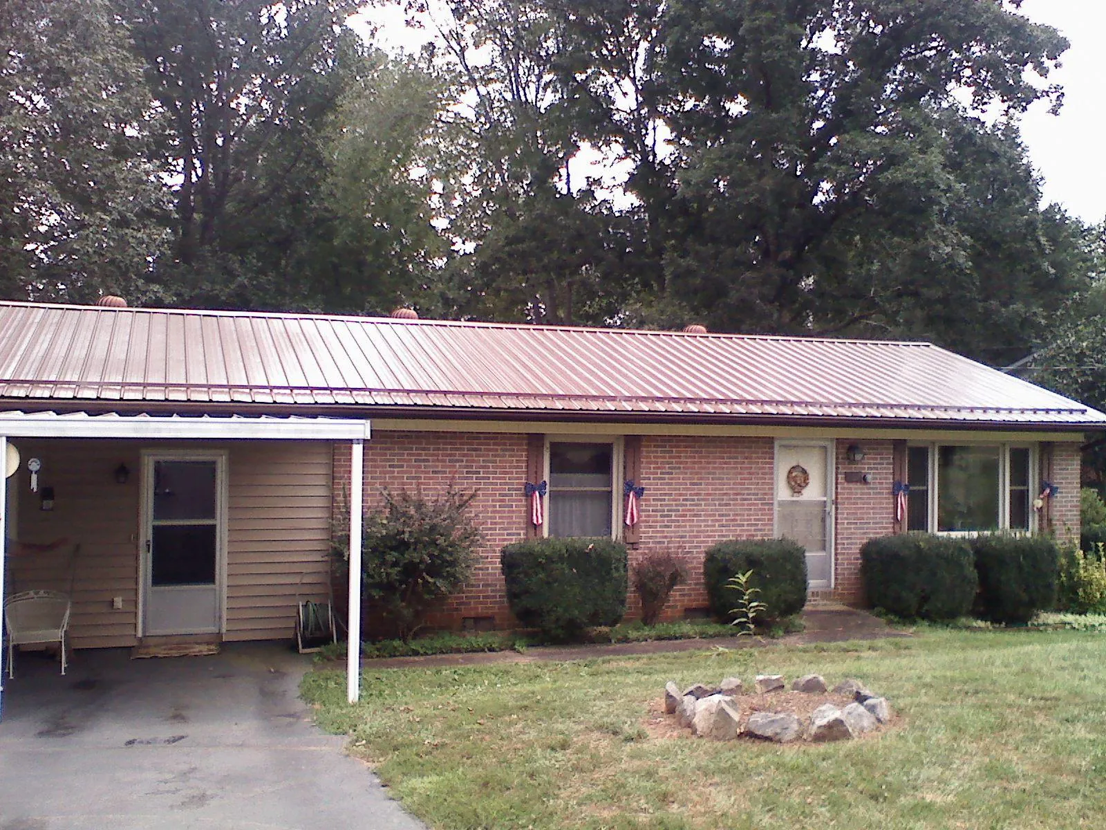Bronze metal roof and carport on a brick ranch home — Roof Repair work by our crew in Central Valley