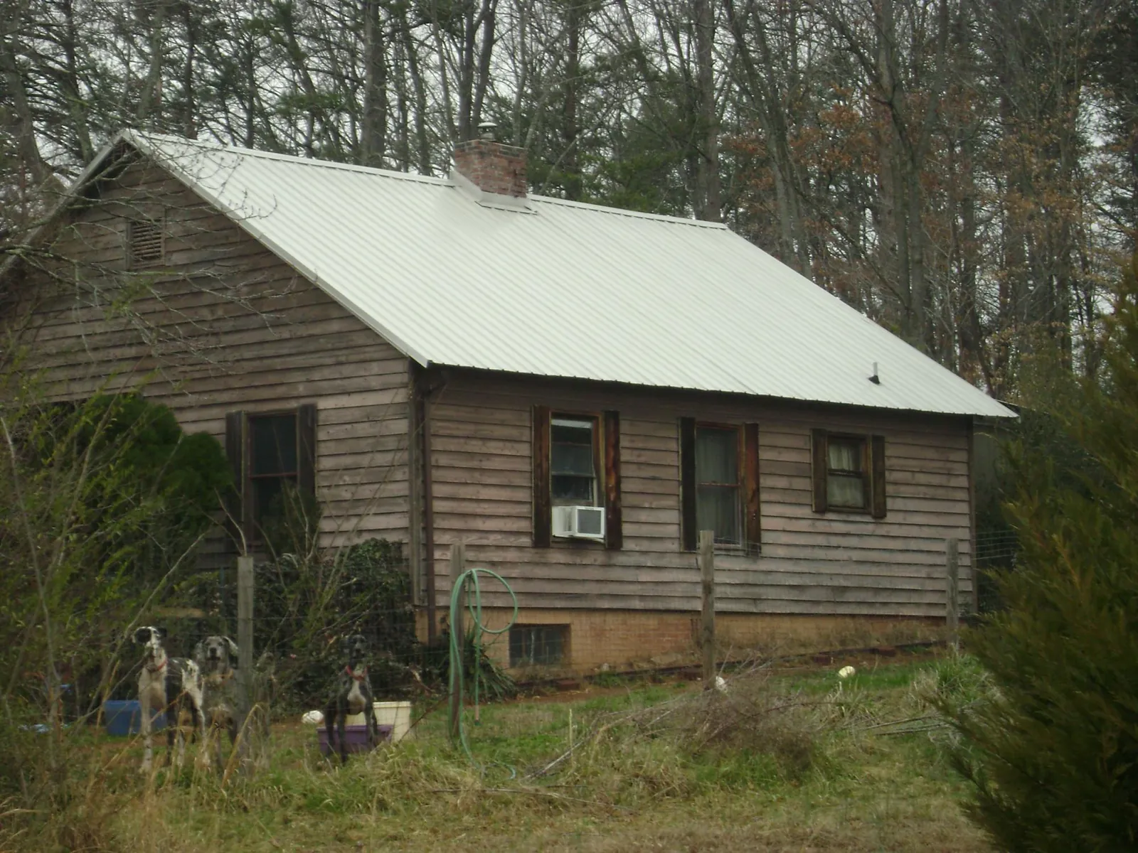 White metal roof on an old wood sided farmhouse, from a Metal Roof Installation job in Central Valley